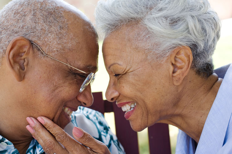 Senior couple smiling face to face