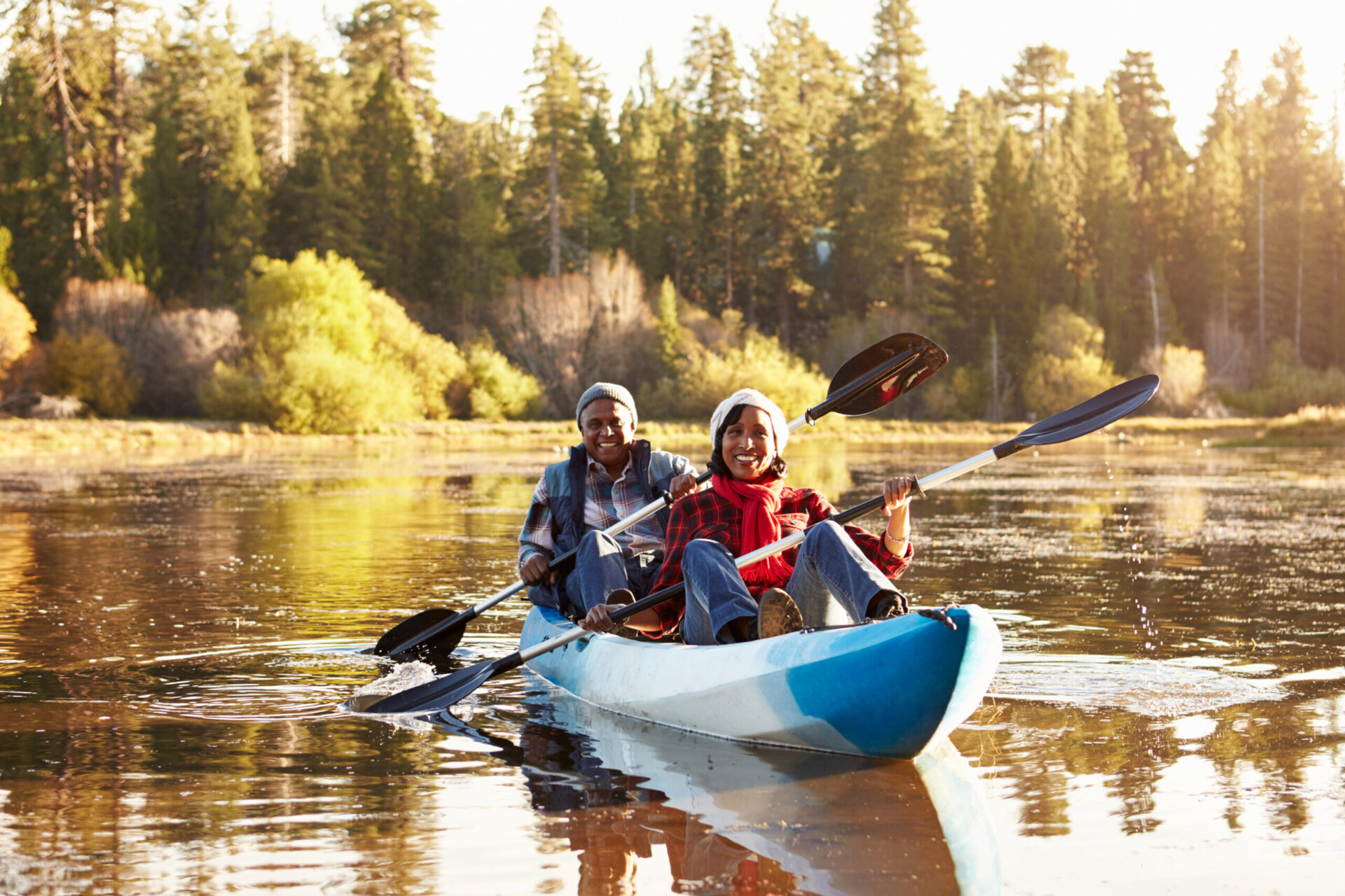 Couple paddling kayak in lake