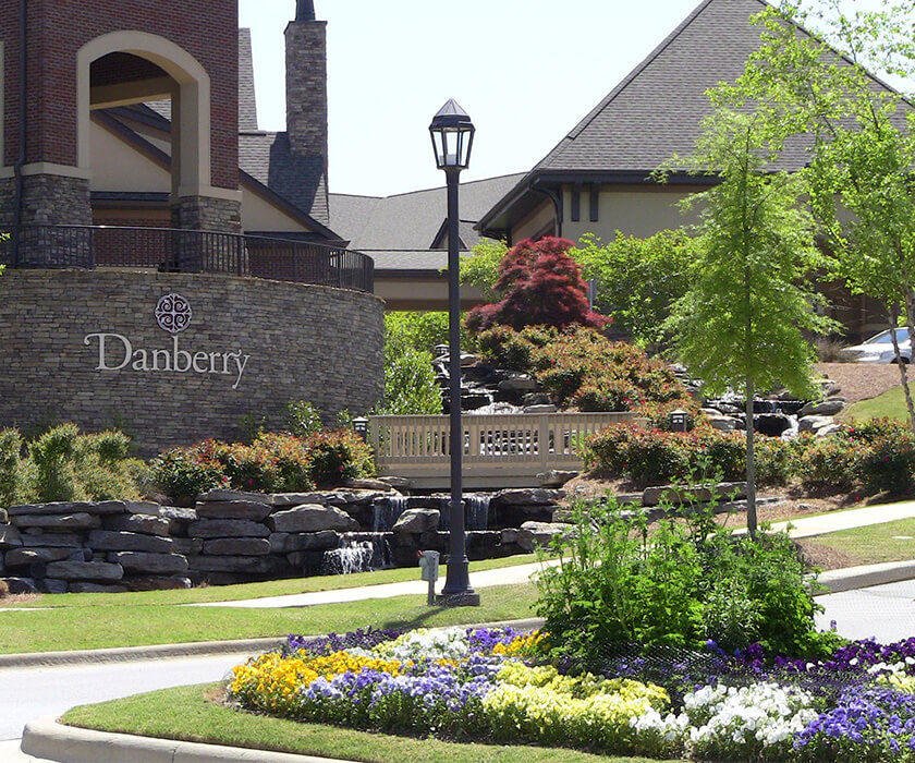 Beautiful entrance to Danberry with colorful flowers and stone architecture.