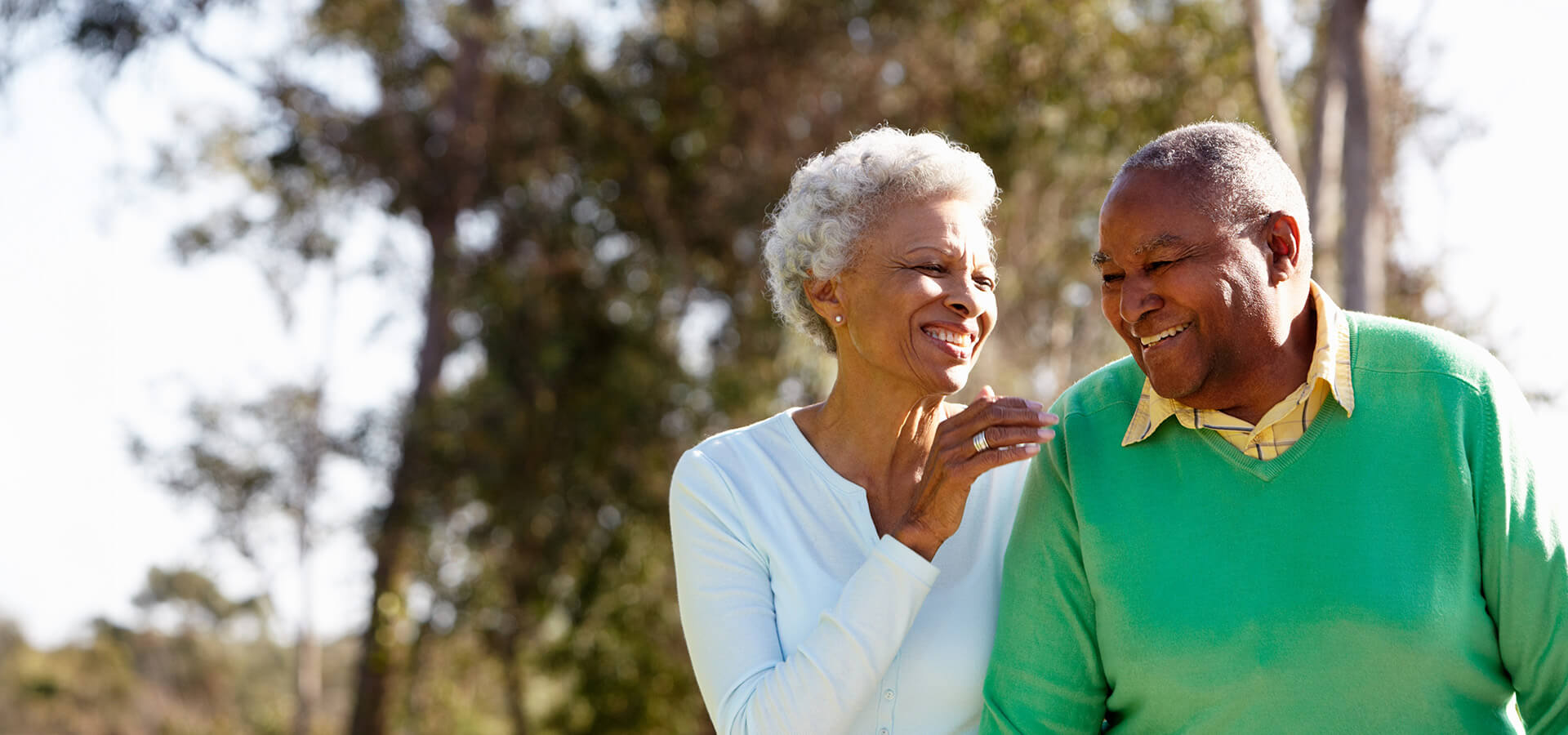 Smiling senior couple enjoying a sunny day outdoors.
