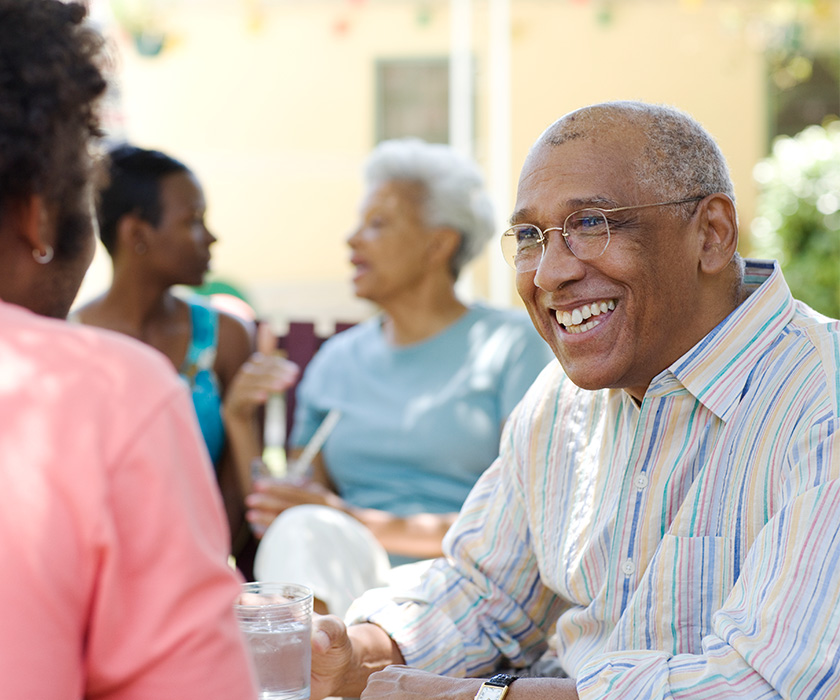 Senior man smiling to woman at event