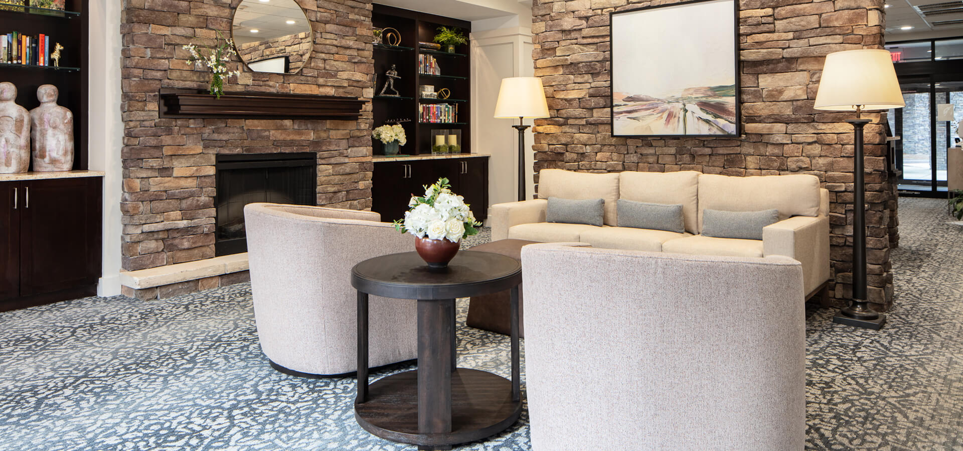 Welcoming lobby of the assisted living area with a couch and chairs.